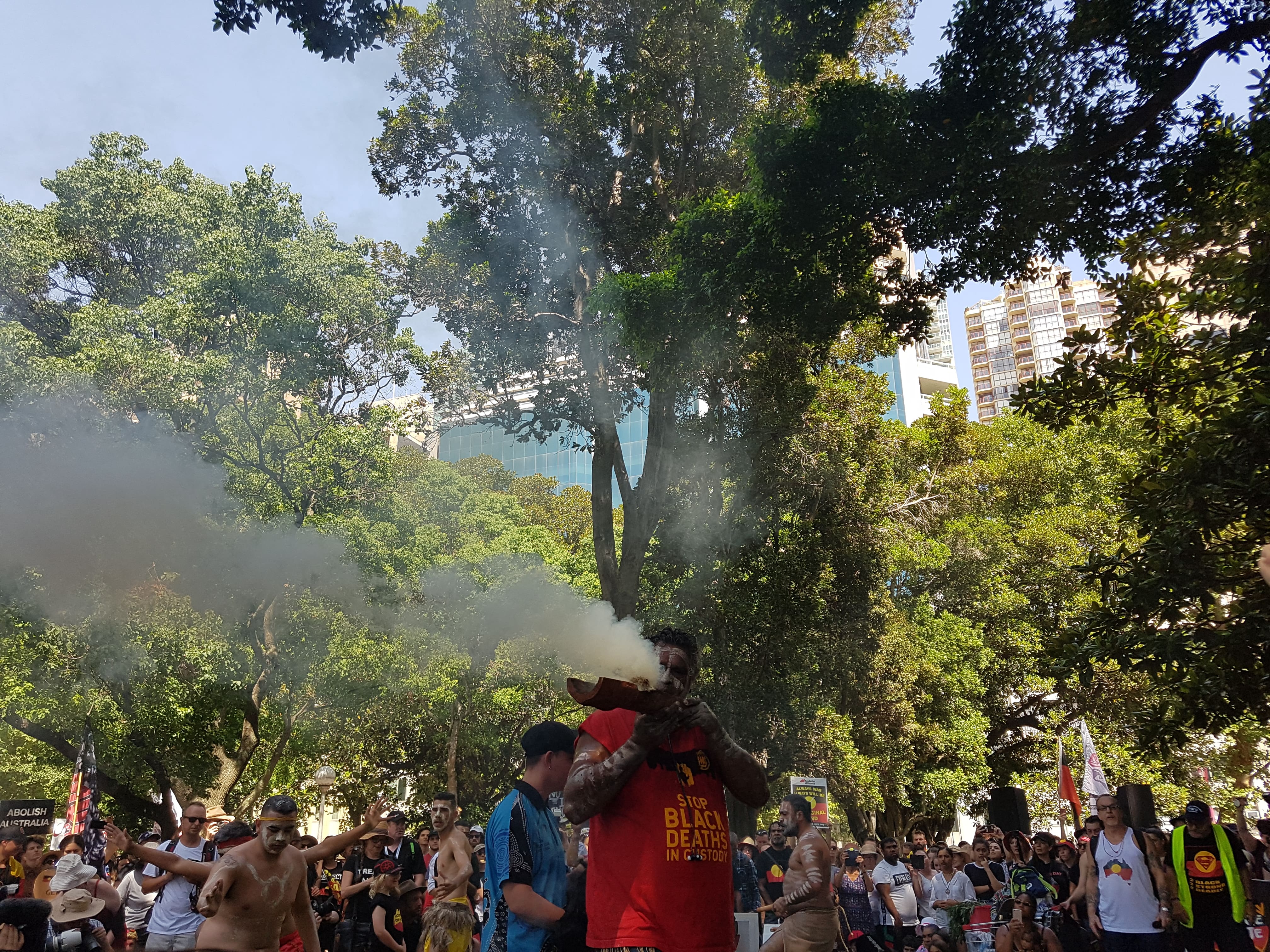 A smoking ceremony takes place after the acknowledgement of country at the Invasion Day 2019 Rally in Sydney.
