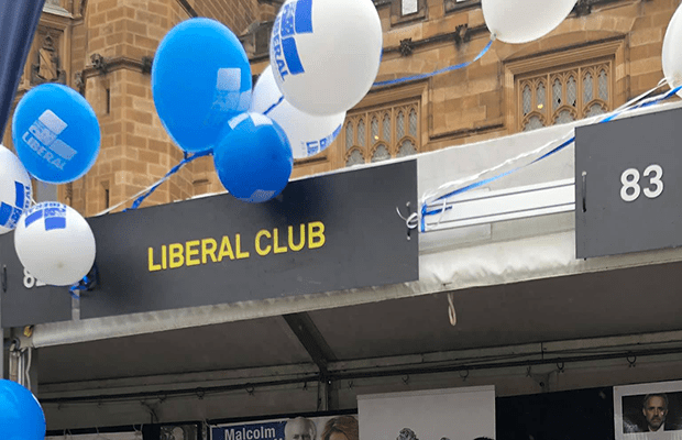 Image of SULC stall signpost which reads "Liberal Club" surrounded by blue and white balloons