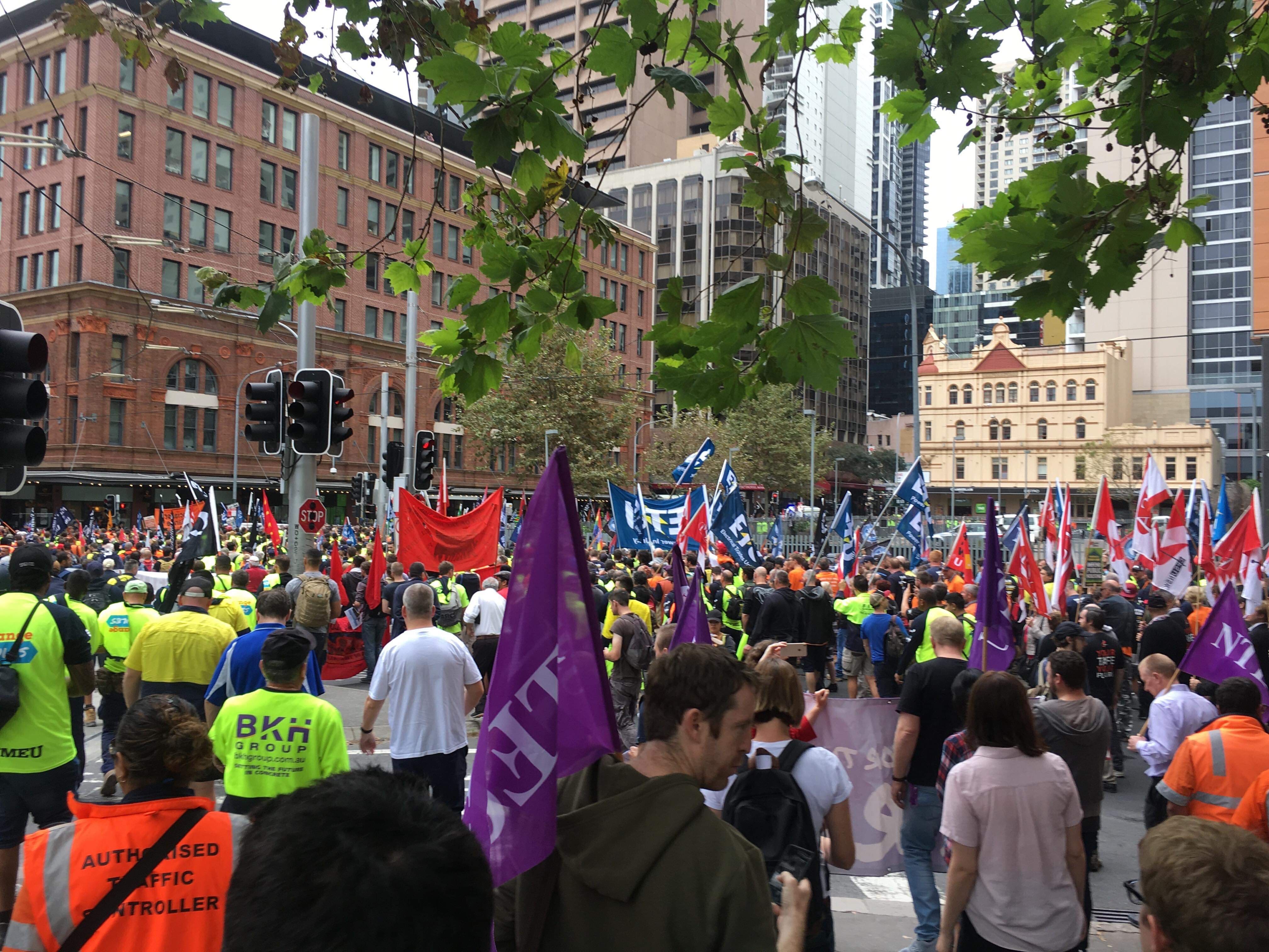 The crowd passes Central and Hay Street, shown in its full scale, with flags from various unions populating the image.