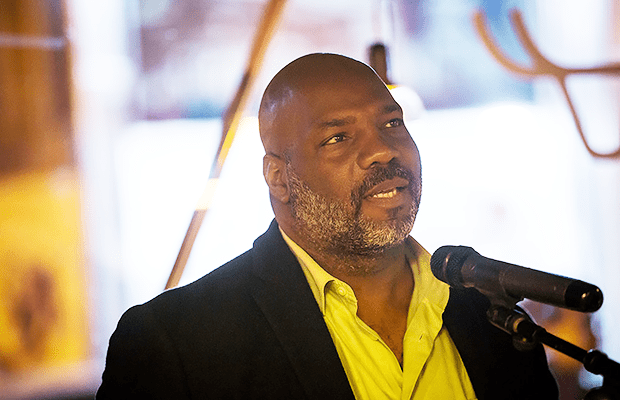 Photograph of Jelani Cobb in a white suit shirt and navy jacket