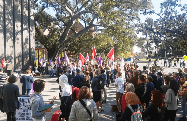 Photo taken from outside Fisher library of a crowd of students at the rally.