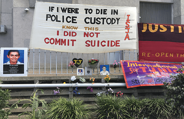 Memorial set-up for TJ Hickey on the fence where he passed away, banner reads "IF I WERE TO DIE IN POLICE CUSTODY, KNOW THIS, I DID NOT COMMIT SUICIDE"