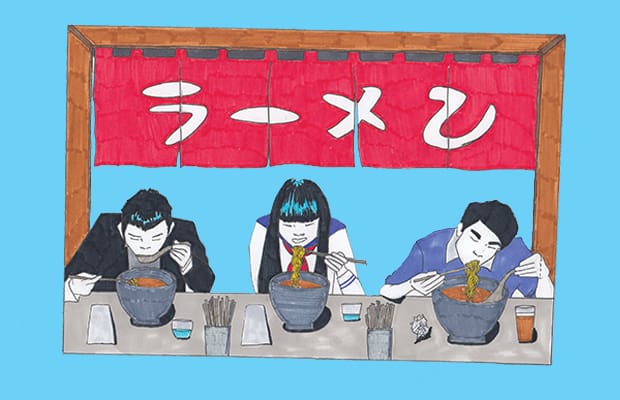 Three people eating at a ramen shop